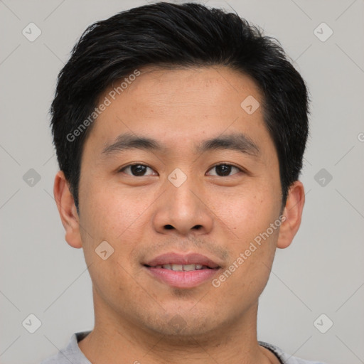 Joyful asian young-adult male with short  black hair and brown eyes