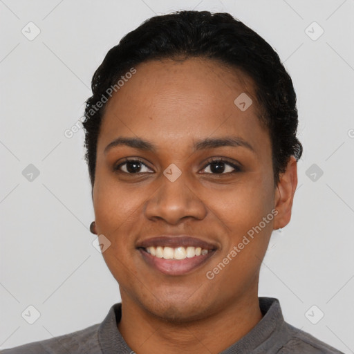 Joyful black young-adult female with short  black hair and brown eyes