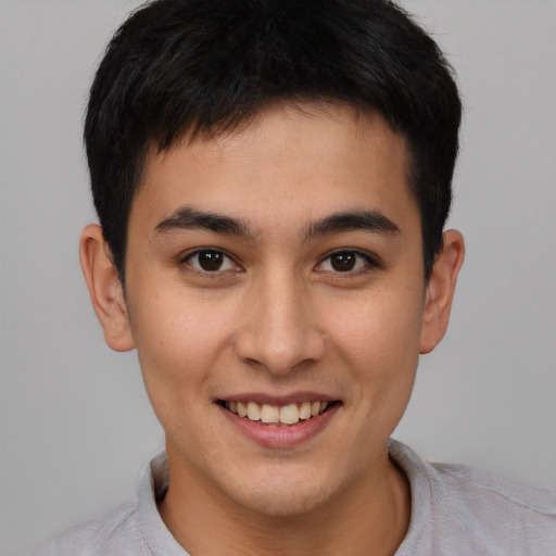 Joyful asian young-adult male with short  brown hair and brown eyes