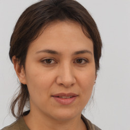 Joyful white young-adult female with medium  brown hair and brown eyes