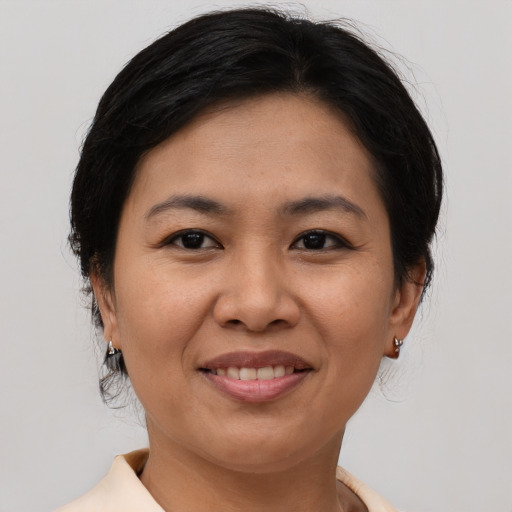 Joyful asian adult female with medium  brown hair and brown eyes