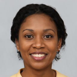 Joyful black adult female with short  brown hair and brown eyes