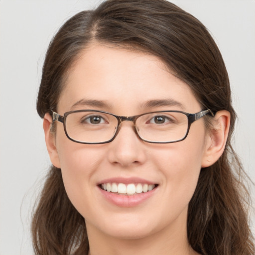 Joyful white young-adult female with long  brown hair and grey eyes