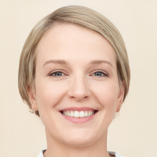 Joyful white young-adult female with medium  brown hair and blue eyes