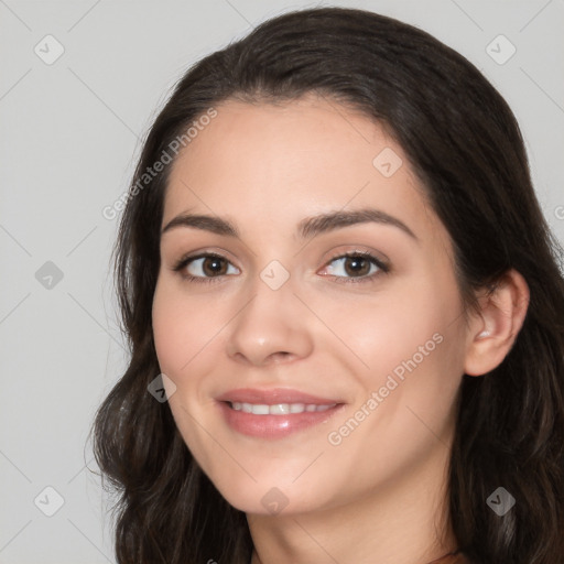 Joyful white young-adult female with long  black hair and brown eyes