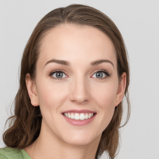 Joyful white young-adult female with medium  brown hair and blue eyes