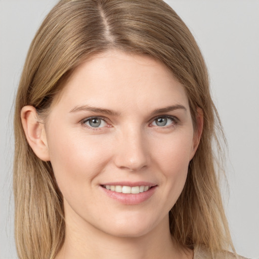 Joyful white young-adult female with long  brown hair and grey eyes