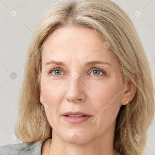 Joyful white adult female with medium  brown hair and blue eyes