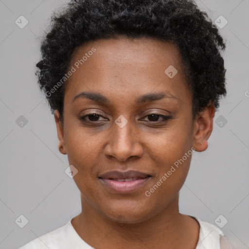 Joyful black young-adult female with short  black hair and brown eyes