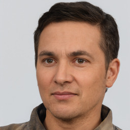 Joyful white adult male with short  brown hair and brown eyes