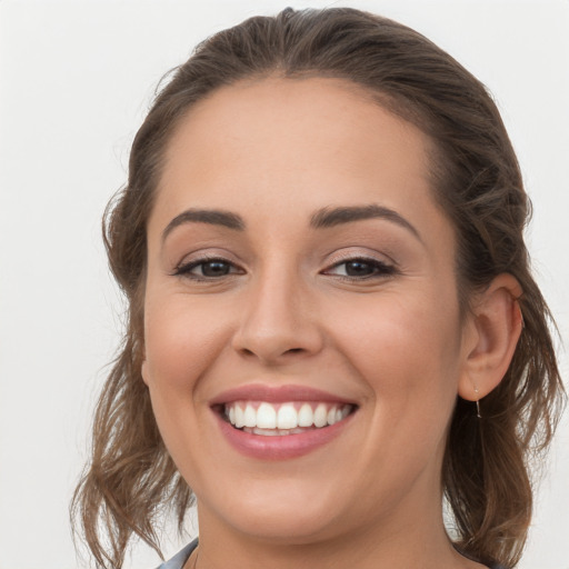 Joyful white young-adult female with long  brown hair and brown eyes