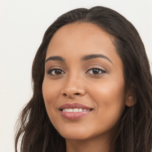 Joyful latino young-adult female with long  brown hair and brown eyes