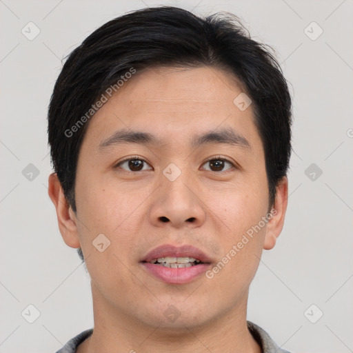 Joyful asian young-adult male with short  brown hair and brown eyes