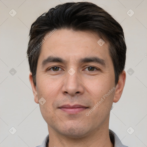 Joyful white adult male with short  black hair and brown eyes