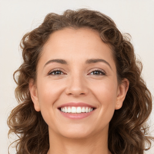 Joyful white young-adult female with long  brown hair and brown eyes