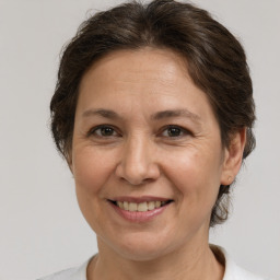 Joyful white adult female with medium  brown hair and brown eyes