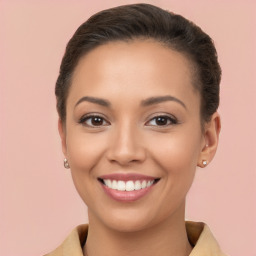 Joyful white young-adult female with long  brown hair and brown eyes