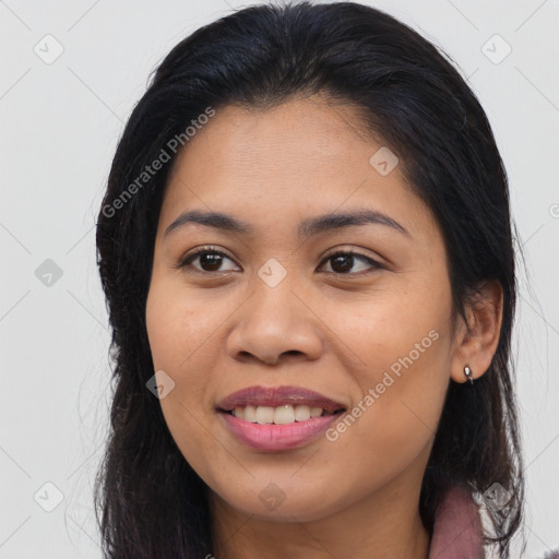 Joyful latino young-adult female with long  brown hair and brown eyes