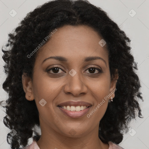 Joyful black young-adult female with long  brown hair and brown eyes