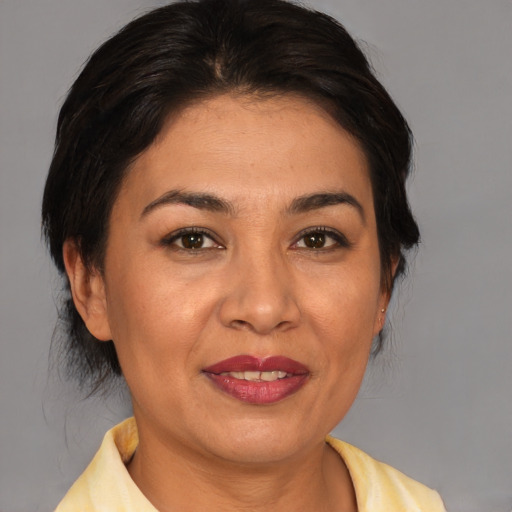 Joyful asian adult female with medium  brown hair and brown eyes