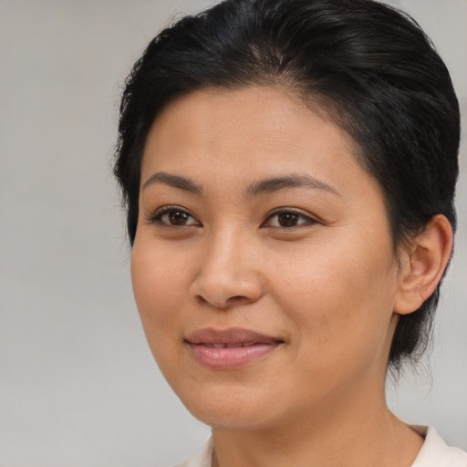 Joyful asian young-adult female with medium  brown hair and brown eyes
