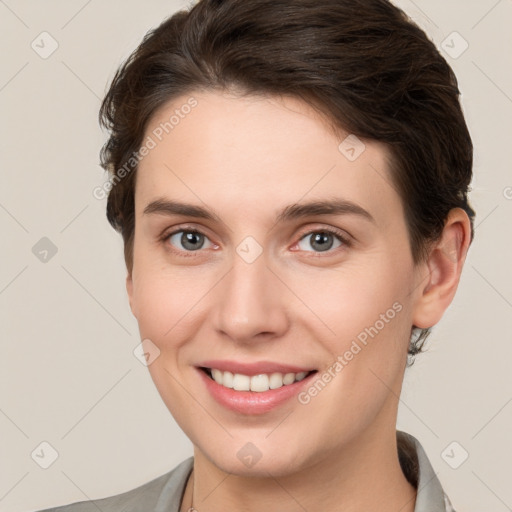 Joyful white young-adult female with short  brown hair and brown eyes