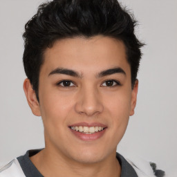 Joyful asian young-adult male with short  brown hair and brown eyes