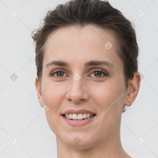 Joyful white young-adult female with short  brown hair and brown eyes