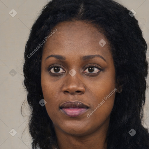 Joyful black young-adult female with long  black hair and brown eyes