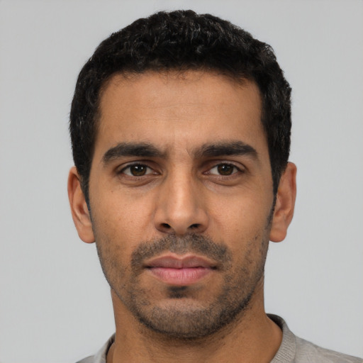 Neutral latino young-adult male with short  black hair and brown eyes