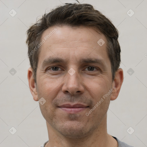 Joyful white adult male with short  brown hair and brown eyes