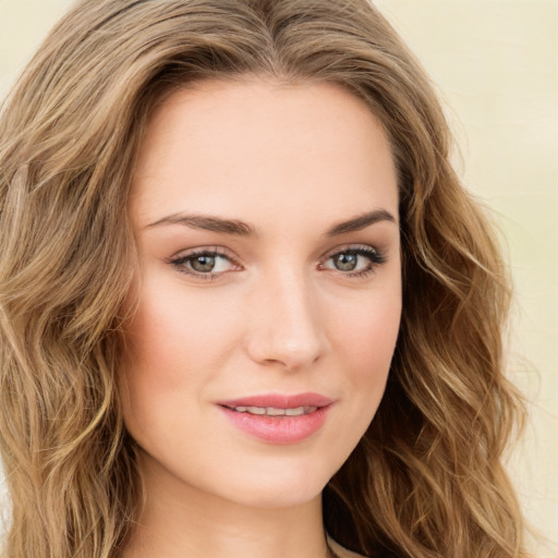 Joyful white young-adult female with long  brown hair and green eyes