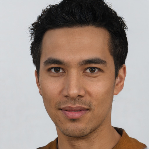Joyful asian young-adult male with short  black hair and brown eyes