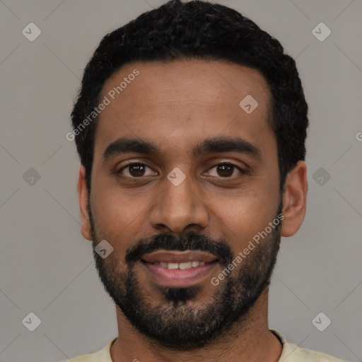 Joyful black young-adult male with short  black hair and brown eyes