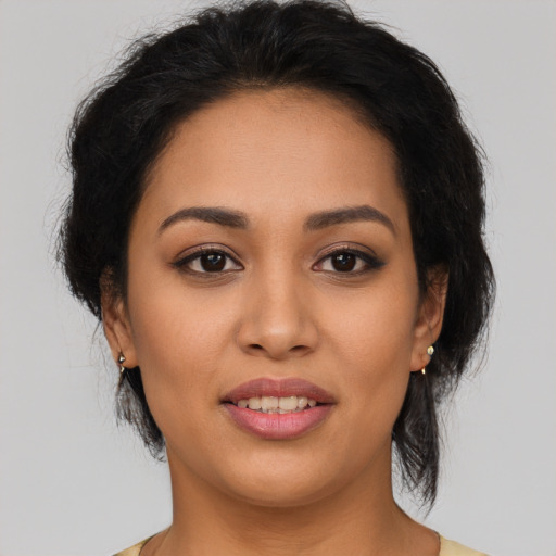 Joyful latino young-adult female with medium  brown hair and brown eyes