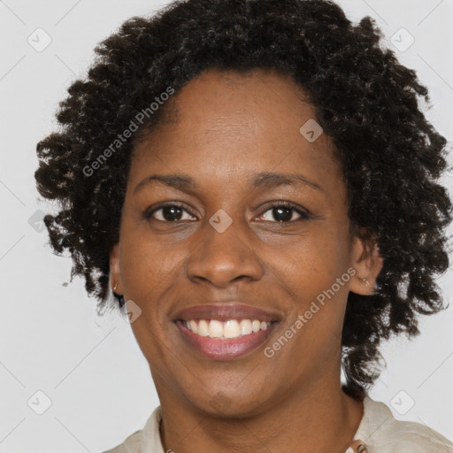 Joyful black adult female with short  brown hair and brown eyes