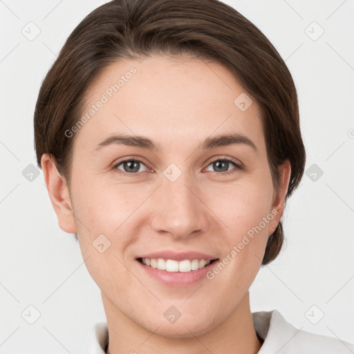 Joyful white young-adult female with short  brown hair and grey eyes