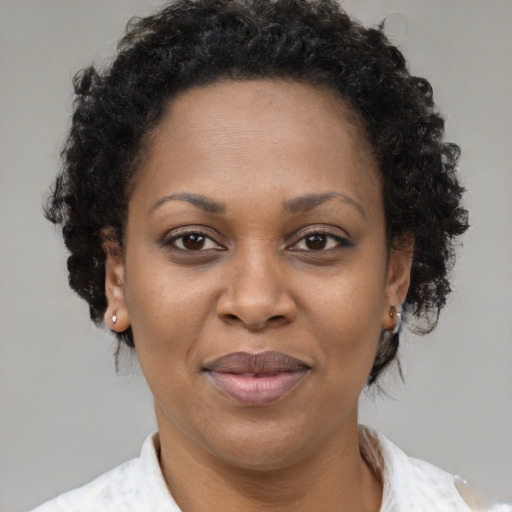 Joyful black adult female with short  brown hair and brown eyes