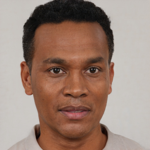 Neutral black adult male with short  black hair and brown eyes