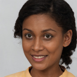 Joyful black young-adult female with medium  brown hair and brown eyes