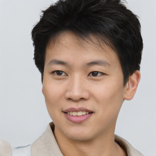 Joyful asian young-adult male with short  brown hair and brown eyes