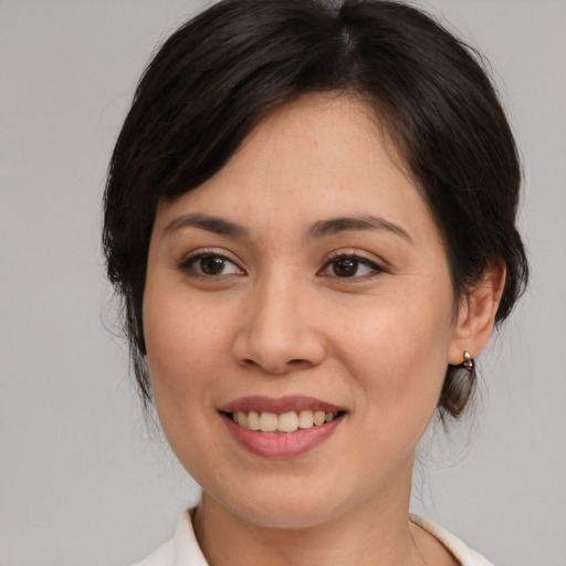 Joyful white young-adult female with medium  brown hair and brown eyes