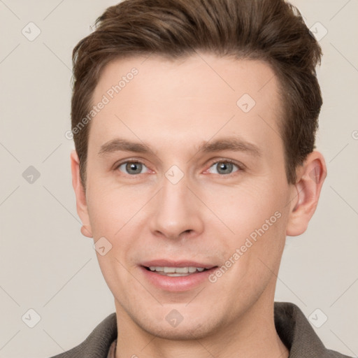 Joyful white young-adult male with short  brown hair and grey eyes