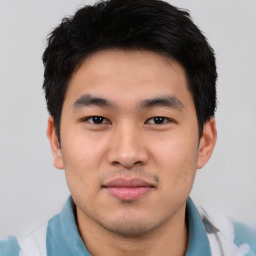 Joyful asian young-adult male with short  black hair and brown eyes