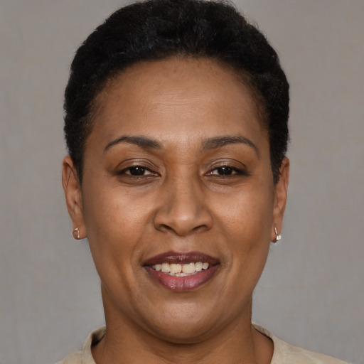 Joyful latino adult female with short  brown hair and brown eyes