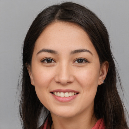 Joyful white young-adult female with long  brown hair and brown eyes