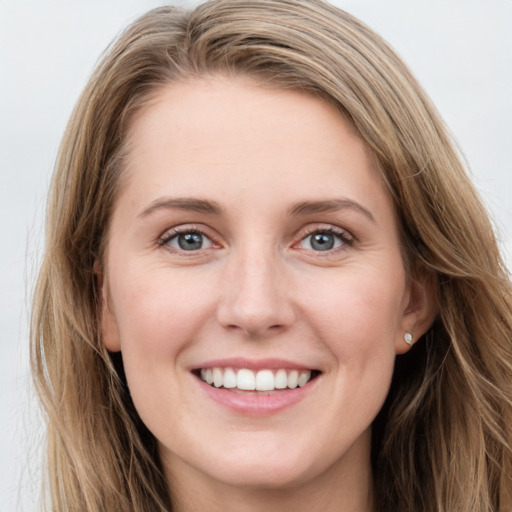 Joyful white young-adult female with long  brown hair and blue eyes