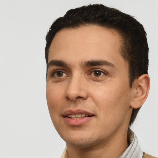 Joyful white young-adult male with short  black hair and brown eyes