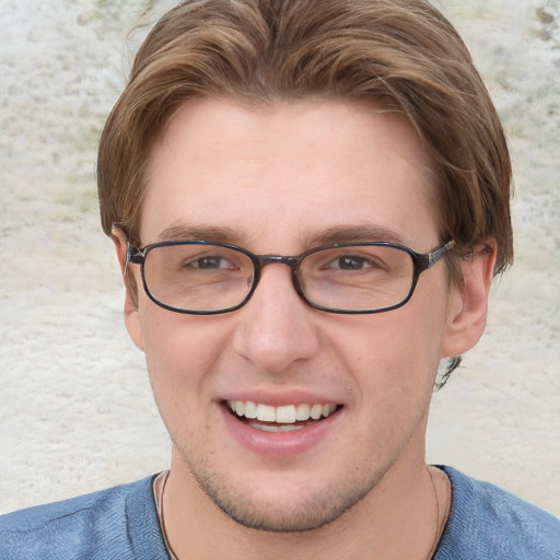 Joyful white young-adult male with short  brown hair and blue eyes