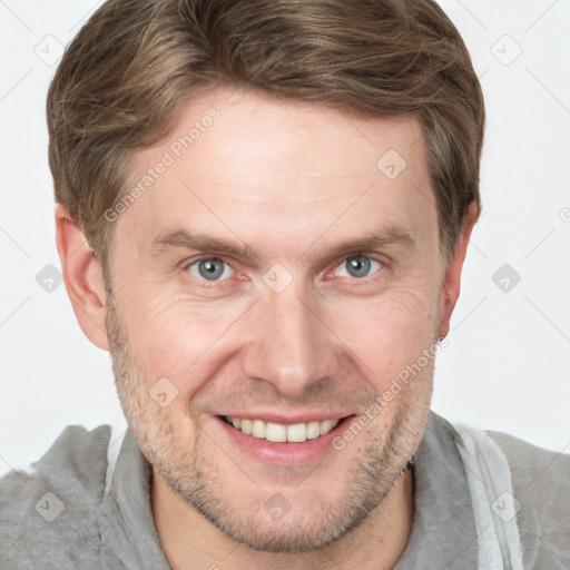 Joyful white adult male with short  brown hair and grey eyes